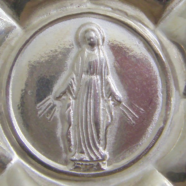 (p1326)Miracle medal with image of Virgien Mary.